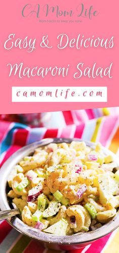 a bowl filled with macaroni salad on top of a colorful table cloth next to a