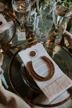 the table is set with wine glasses, napkins and place settings for dinner guests