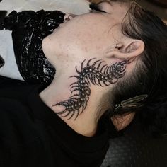 a man with a dragon tattoo on his neck