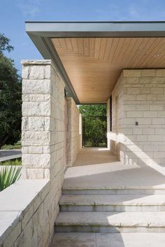 an outdoor walkway leading up to a house