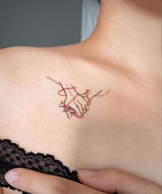 a woman's shoulder with a red line drawing on it and a hand pointing towards the viewer