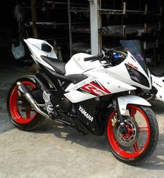 a white and red motorcycle parked in front of a building