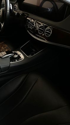 the interior of a modern car with black leather