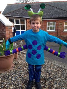 a young boy dressed up as a toy story book character in front of a house