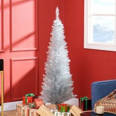 a small silver christmas tree in a living room