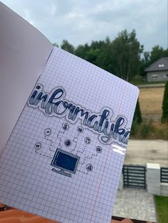 someone holding up a notebook with the word insommatia written in blue ink