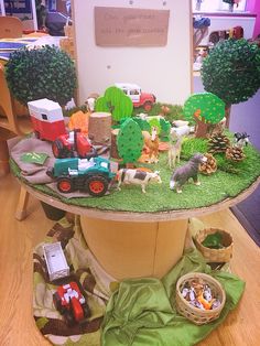 a table topped with lots of toys on top of a wooden floor