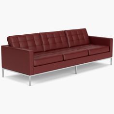 a red leather couch sitting on top of a white floor next to a metal frame