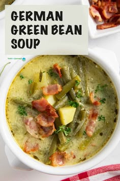 a white bowl filled with green bean soup and topped with bacon, potatoes and parsley