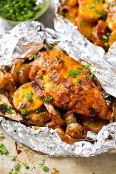 chicken and potatoes wrapped in foil with parsley