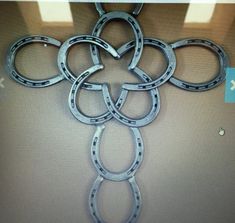 the metal rings are hanging on the wall in front of the computer screen, which is displaying an image of four interlocked circles