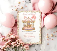 a pink and gold carousel birthday party with balloons