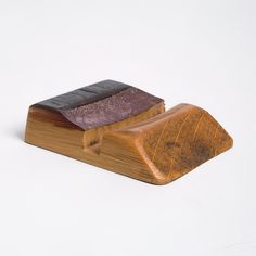 two small wooden objects sitting on top of each other