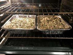 two trays of food cooking in an oven