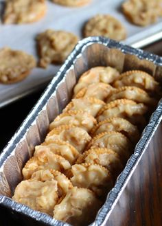 some food is sitting in a tin on a table next to trays of muffins