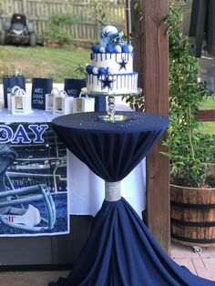 a table topped with a blue and white cake