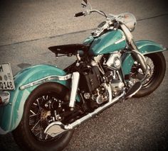 a blue motorcycle is parked on the street