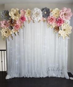 the backdrop is decorated with flowers and sequins