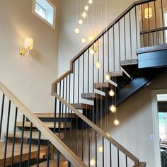 a set of stairs with light bulbs hanging from the top and bottom handrails