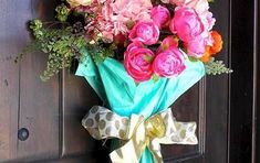 a bouquet of flowers sitting on top of a wooden door