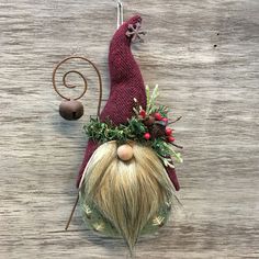 a gnome's head hanging on the side of a wooden wall with an ornament attached to it