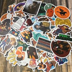 many different stickers on a wooden surface