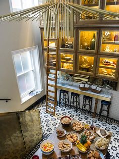 a table filled with lots of food on top of a tiled floor