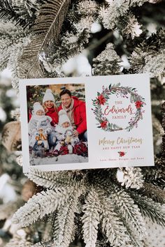 an ornament hanging from the christmas tree with two photos on it and evergreen branches