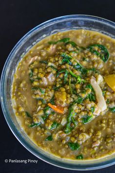 a bowl filled with soup and vegetables on top of a table