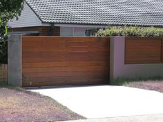 a wooden gate in front of a house