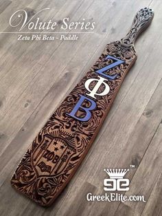 a wooden paddle with the letter p on it sitting on top of a hard wood floor