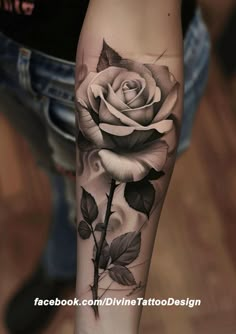 a black and white rose tattoo on the arm