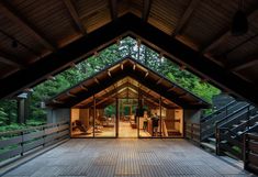 the inside of a building with wooden floors and stairs leading up to an open door