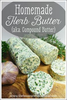 homemade herb butter is shown on a wooden cutting board with garlic and herbs around it