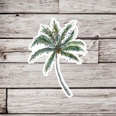 a palm tree sticker sitting on top of a wooden table