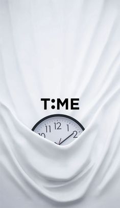 a clock in the middle of a white sheet with time on it's face