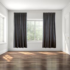 an empty room with wood floors and black curtains