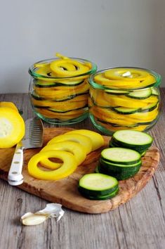 sliced zucchini and squash on a cutting board with a knife next to them