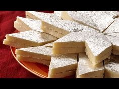 several pieces of white cake on a red plate with a red towel in the background