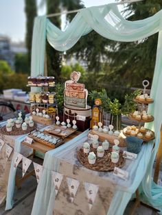 a table topped with lots of cakes and cupcakes