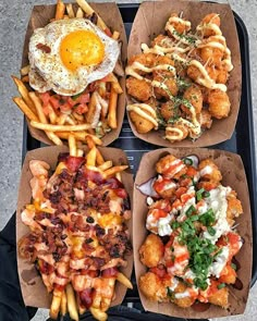 four takeout boxes filled with different types of food