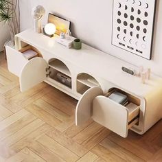 a living room with a white table and some chairs on the floor next to it