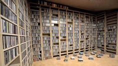 a room filled with lots of bookshelves and shelves full of dvd's