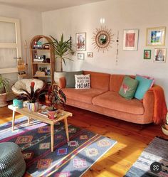 a living room filled with furniture and lots of pictures hanging on the wall above it