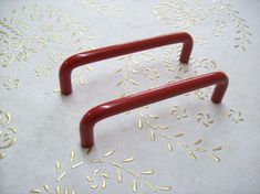 a pair of red handles sitting on top of a table