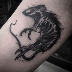 a man's arm with a black and white tattoo design on it, depicting a skeleton riding a horse