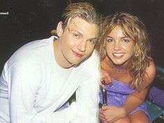 a young man and woman sitting next to each other