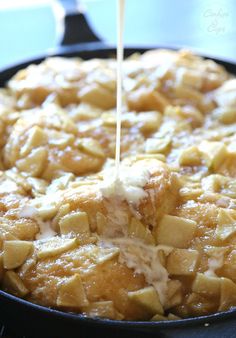 someone is drizzling something on top of some food in a skillet