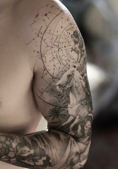 a man with tattoos on his arm and chest