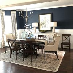 a dining room table with chairs and a chandelier